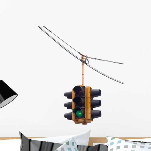 Green traffic light hanging from a cable, isolated on white. Wall Decal