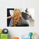 Blonde curly hair. Hairdresser doing hairstyle for young woman i Wall Mural