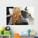 Blonde curly hair. Hairdresser doing hairstyle for young woman i Wall Mural