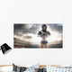 American football female player is posing Wall Mural