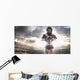 American football female player is posing Wall Mural