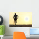 Back view silhouette of a runner man running on the beach Wall Mural