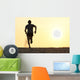 Back view silhouette of a runner man running on the beach Wall Mural