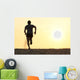 Back view silhouette of a runner man running on the beach Wall Mural