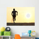 Back view silhouette of a runner man running on the beach Wall Mural