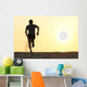Back view silhouette of a runner man running on the beach Wall Mural