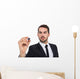 Focused businessman writing with marker Wall Decal