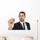 Focused businessman writing with marker Wall Decal