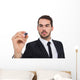 Focused businessman writing with marker Wall Decal