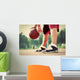 Young man on basketball court dribbling with bal Wall Mural