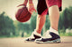 Young man on basketball court dribbling with bal Wall Mural