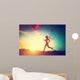 Silhouette of woman running at sunset Wall Mural