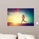 Silhouette of woman running at sunset Wall Mural