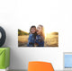 Two cheerful friends snuggling outdoors in the park Wall Mural