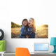 Two cheerful friends snuggling outdoors in the park Wall Mural