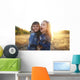 Two cheerful friends snuggling outdoors in the park Wall Mural