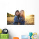 Two cheerful friends snuggling outdoors in the park Wall Mural