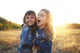 Two cheerful friends snuggling outdoors in the park Wall Mural