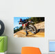 Motocross bike taking off on dirt road. Wall Mural