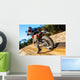 Motocross bike taking off on dirt road. Wall Mural
