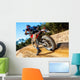 Motocross bike taking off on dirt road. Wall Mural