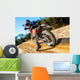 Motocross bike taking off on dirt road. Wall Mural