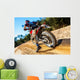 Motocross bike taking off on dirt road. Wall Mural