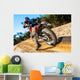Motocross bike taking off on dirt road. Wall Mural