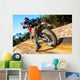 Motocross bike taking off on dirt road. Wall Mural