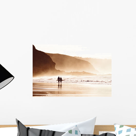 couple walking on beach with fog Wall Mural
