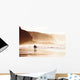 couple walking on beach with fog Wall Mural