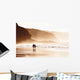 couple walking on beach with fog Wall Mural