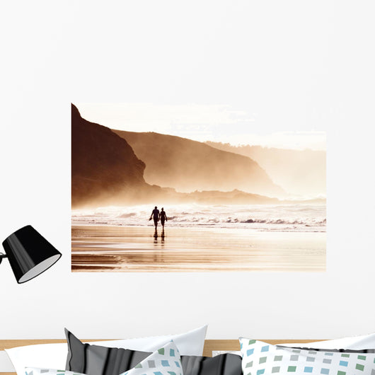 couple walking on beach with fog Wall Mural