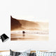 couple walking on beach with fog Wall Mural