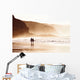 couple walking on beach with fog Wall Mural