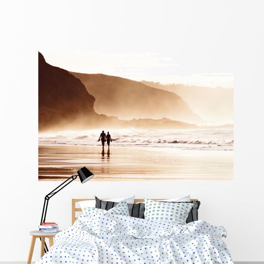 couple walking on beach with fog Wall Mural