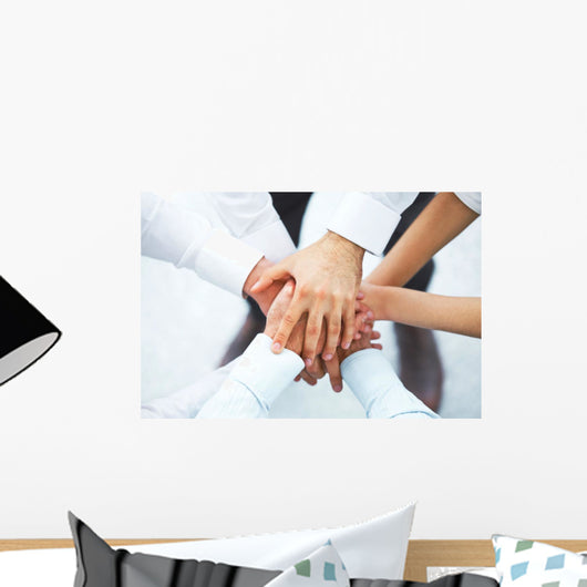 International business team showing unity with their hands toget Wall Mural