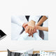 International business team showing unity with their hands toget Wall Mural