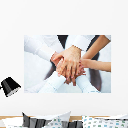 International business team showing unity with their hands toget Wall Mural