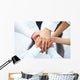 International business team showing unity with their hands toget Wall Mural