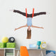 Young woman making aerial yoga exercises in stretching Wall Decal