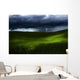 Green land over a storm Wall Mural