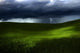 Green land over a storm Wall Mural