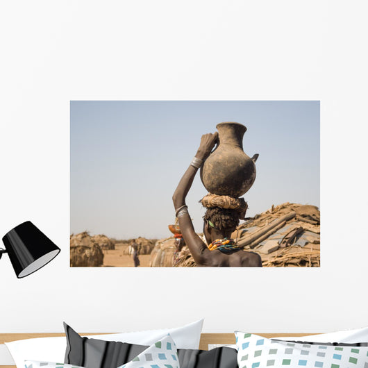 Woman carries on her head a container with water, Ethiopia Wall Mural