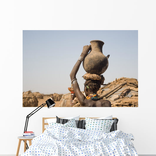 Woman carries on her head a container with water, Ethiopia Wall Mural