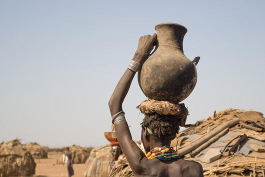 Woman carries on her head a container with water, Ethiopia Wall Mural