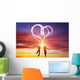 Happy couple in love jump making heart symbol of light Wall Mural