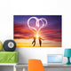 Happy couple in love jump making heart symbol of light Wall Mural