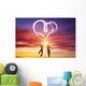 Happy couple in love jump making heart symbol of light Wall Mural