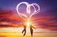 Happy couple in love jump making heart symbol of light Wall Mural